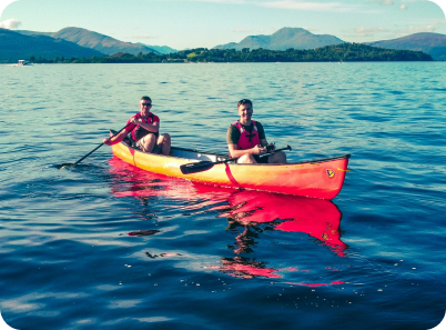 Picture of two people in an orange canoe on a lake